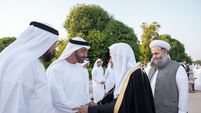 Sheikh Mohamed bin Zayed greets a participant of the Forum for Promoting Peace in Muslim Societies during an Al Maqam Palace barza. Hamad Al Kaabi / Ministry of Presidential Affairs
