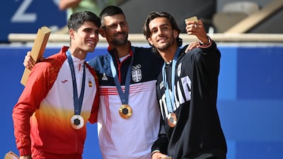 Silver medallist Carlos Alcaraz of Spain, with gold medal winner Novak Djokovic and bronze medallist Lorenzo Musetti. EPA