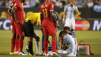 Argentina's Angel di Maria, right, receives a medical attention during a Copa America Group D match against Panama at Soldier Field Friday, June 10, 2016, in Chicago. (AP Photo/Charles Rex Arbogast)