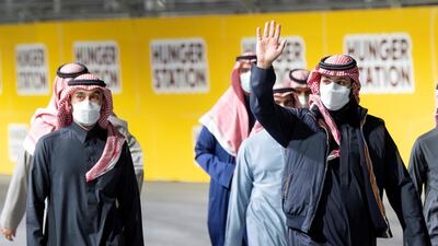 Saudi Crown Prince Mohammed Bin Salman waves as he arrives at Diriyah E-Prix 2021 in Riyadh, Saudi Arabia. Courtesy of Saudi Royal Court