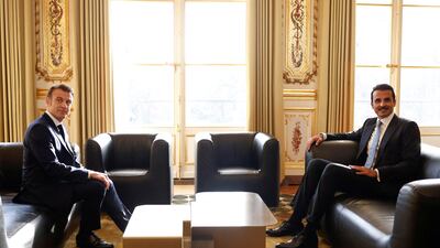 Mr Macron and Sheikh Tamim sit down for talks. Reuters