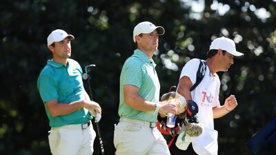 Rory McIlroy walks off the 17th tee as Scottie Scheffler looks on during the final round of the PGA Tour Championship at East Lake Golf Club. AFP