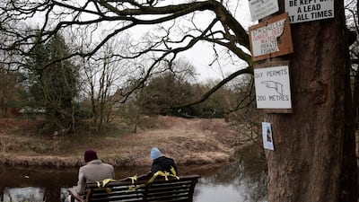 People sit on the bench where the phone was found. Her dog was found running loose on the day she vanished. Getty Images