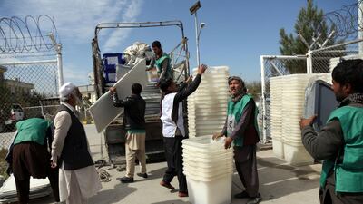 Afghan election workers load ballot boxes and election materials onto a truck. Rahmat Gul / AP