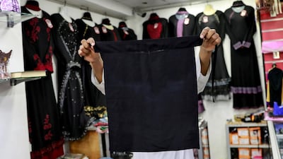 A salesman shows a full face veil, niqab, at a shop selling various kinds of coverings worn by Muslim women in Colombo, Sri Lanka. Reuters