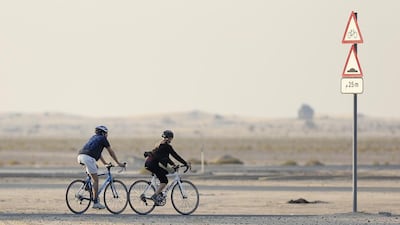 A pair of cyclists at Al Qudra Cycle Track in Dubai. Sarah Dea / The National