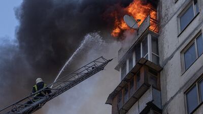 Firefighters tackle a blaze in an apartment building in Kyiv after it was hit by shelling as Russia's invasion of Ukraine continues. Reuters