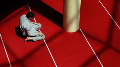 A man prays at the Grand Mosque of Saint-Denis, near Paris. Benjamin Cremel / AFP Photo