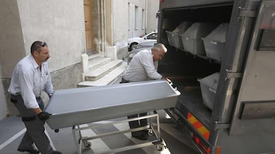 The bodies of the migrants found dead in an abandoned lorry are loaded in to a van at the Department of Forensic Medicine at the Medical University of Vienna. Dieter Nagl / AFP Photo