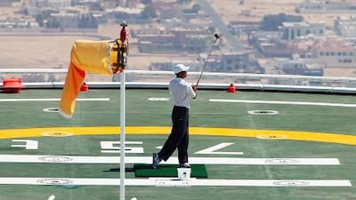 Tiger Woods takes a swing from the helipad on top of the Burj Al Arab Hotel prior to the 2004 Dubai Desert Classic played at the Emirates Golf Club.