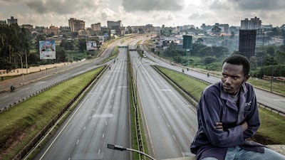 A stranded worker sits on a bridge overlooking the almost-empty Thika Superhighway in Nairobi, Kenya, on the second day of a nationwide transport strike over rising fuel prices. AFP