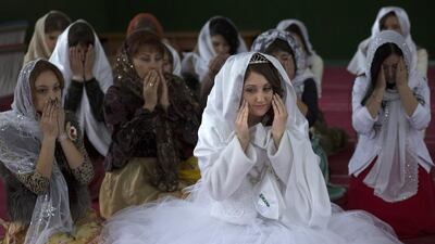 Sera Aliyeva, centre, surrounded by her relatives and friend, prays during wedding in a mosque in Sary-Su, Crimea. Crimea’s 300,000 Tatar Muslims feel particularly vulnerable because of their tenuous hold on the homes and land they inhabit. Alexander Zemlianichenko / AP Photo