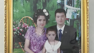A family portrait photographed after the husband was released from a vocational training centre in early 2019. The family celebrated his graduation from the centre with a party and hung the portrait in their living room.