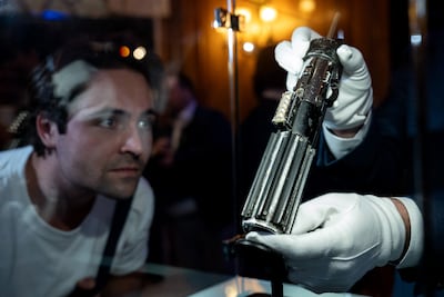 A lightsaber wielded by Darth Vader in two films Star Wars on sale in Los Angeles. AFP