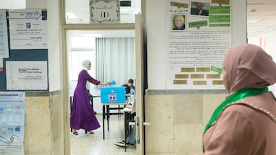 An Arab woman casts her vote during Israel's general election in 2022. Community leaders are campaigning for a greater turnout this year. Getty Images