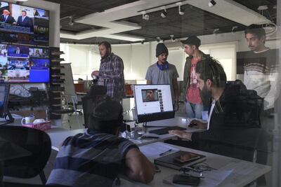 Ahmed Al Basheer works with his show's research team at the company offices in Amman. The research team's work consists of monitoring dozens of Iraqi television channels to spot important and original news. Sebastian Castelier