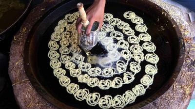 A vendor preparing sweets as time to break the fast approaches, in Herat, Afghanistan. EPA