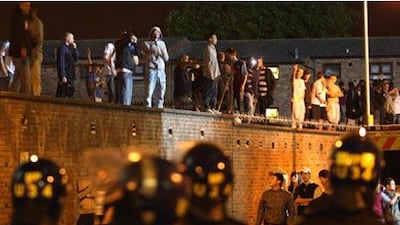 Riot police officers and supporters outside Upton Park last night. A fan was stabbed during large scale violence before the League Cup second round clash between West Ham and Millwall, while the match was interrupted by a pitch invasion.