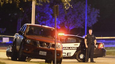 Police stand guard outside an exhibition centre in Texas where police killed two gunmen after they attacked the building which was hosting an anti-Islamic event. EPA