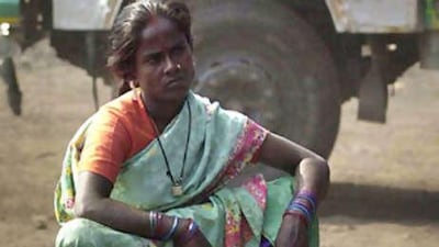 A migrant sex worker waits for a customer near a motorway in Gauhati, India.