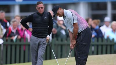 Tiger Woods is watched by coach Sean Foley on August 25, 2014. AP Photo