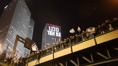 Protesters lineup on a walkway in Tel Aviv. AFP