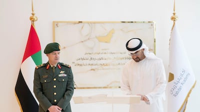 Sheikh Mohammed bin Zayed signs a guest book during the inauguration of the Rabdan Academy. Seen with Major General Mike Hindmarsh. Rashed Al Mansoori / Crown Prince Court - Abu Dhabi