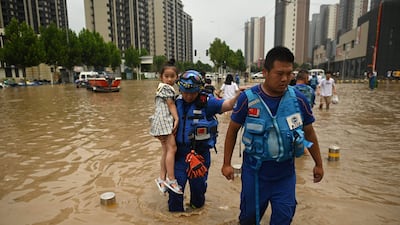 Members of the Blue Sky rescue team carry a girl to safety.