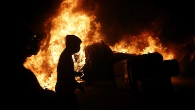 Flames erupt as the protests barrel on into the night. EPA