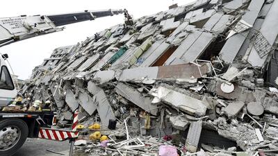 In this photo released by China’s Xinhua News Agency, rescuers search for survivors at a quake site in Tainan. Zhang Guojun / Xinhua via AP