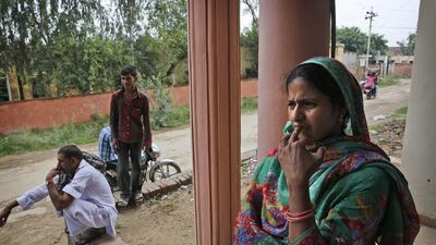 Sreeja Berwal, who is from the southern state of Kerala, stands outside a rural bank in Sorkhi. Sreeja, whose family was in dire financial straits, agreed for her to marry a Haryana man seeking a wife, who did not have to provide a dowry.