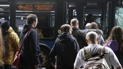 People wait to board public transportation outside the central terminal of LaGuardia Airport. Shannon Stapleton / Reuters