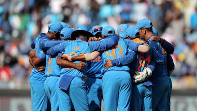 India in a huddle just before the game. Chris Whiteoak / The National
