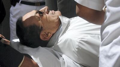 Former Egyptian President Hosni Mubarak is wheeled out of the courtroom after his trial, at the police academy in Cairo April 13, 2013. Reuters