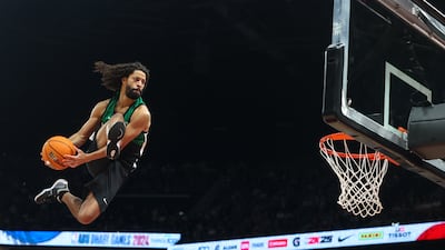 A basketball trick shot player entertains the crowd during the half-time show. Victor Besa / The National