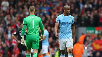 Vincent Kompany, right, of Manchester City looks dejected at the end of the Premier League match between Liverpool and Manchester City at Anfield on April 13, 2014, in Liverpool, England. Alex Livesey / Getty Images