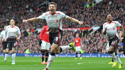 Liverpool's English midfielder Steven Gerrard (celebrates after scoring his team's second goal during the English Premier League football match between Manchester United and Liverpool at Old Trafford in Manchester, Northwest England, on March 16, 2014. Paul Ellis/ AFP