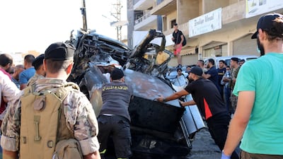 A crowd surrounds the vehicle in which Muhammad Hamid Jabara was killed by an Israeli air strike in Ghazzeh, in Lebanon's Bekaa region. AFP