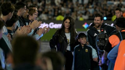 Lionel Messi, his wife Antonela Rocuzzo and their son Ciro leave the pitch. AFP