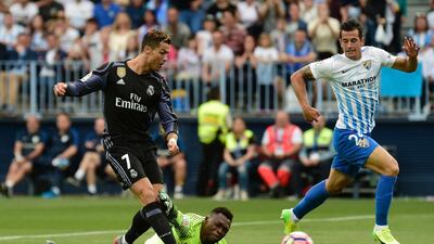 Real Madrid’s Portuguese forward Cristiano Ronaldo scores against Malaga. Jose Jordan / AFP