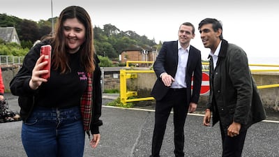 A member of the public takes a selfie with Rishi Sunak during a visit to Scotland in August 2020. AFP