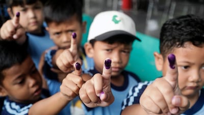 Children show their ink-marked fingers after receiving polio vaccine doses in Jakarta, Indonesia. EPA
