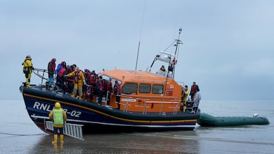 A group of people, thought to be migrants, are brought to Dungeness, Kent, by the coastguard after a small boat incident in the Channel. PA