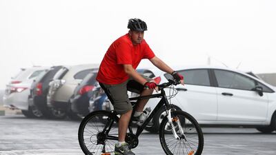 Clive Piper riding his bike in the Tecom area of Dubai. Pawan Singh / The National