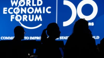 A screen silhouettes attendees at Davos. Bloomberg