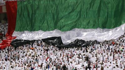 UAE supporters unveil a huge flag during their 2018 World Cup Asia qualifying match against Saudi Arabia on Tuesday night in Abu Dhabi. Karim Sahib / AFP / March 29, 2016