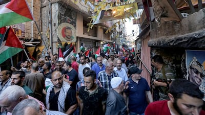 Palestinian wave their national flag in southern Beirut, protesting against the Bahrain conference. EPA