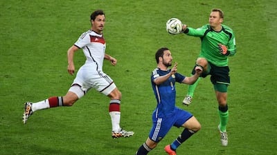 Germany goalkeeper Manuel Neuer, right, and Argentine forward Gonzalo Higuain, centre, compete for the ball during the 2014 Fifa World Cup final at the Maracana Stadium in Rio de Janeiro on July 13, 2014. Gabriel Boys / AFP