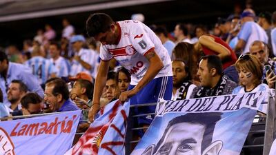 Fans put up banners before the match between Argentina and Chile. (Elsa/Getty Images/AFP)