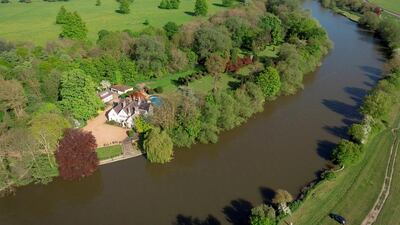 The island is located in the middle of the river, opposite the meadow of Runnymede. Courtesy Sotheby’s International Realty